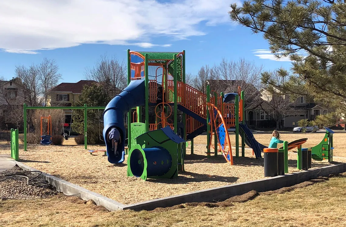 Tube slide and tunnel playground elements at North Range Village Park in Commerce City, CO
